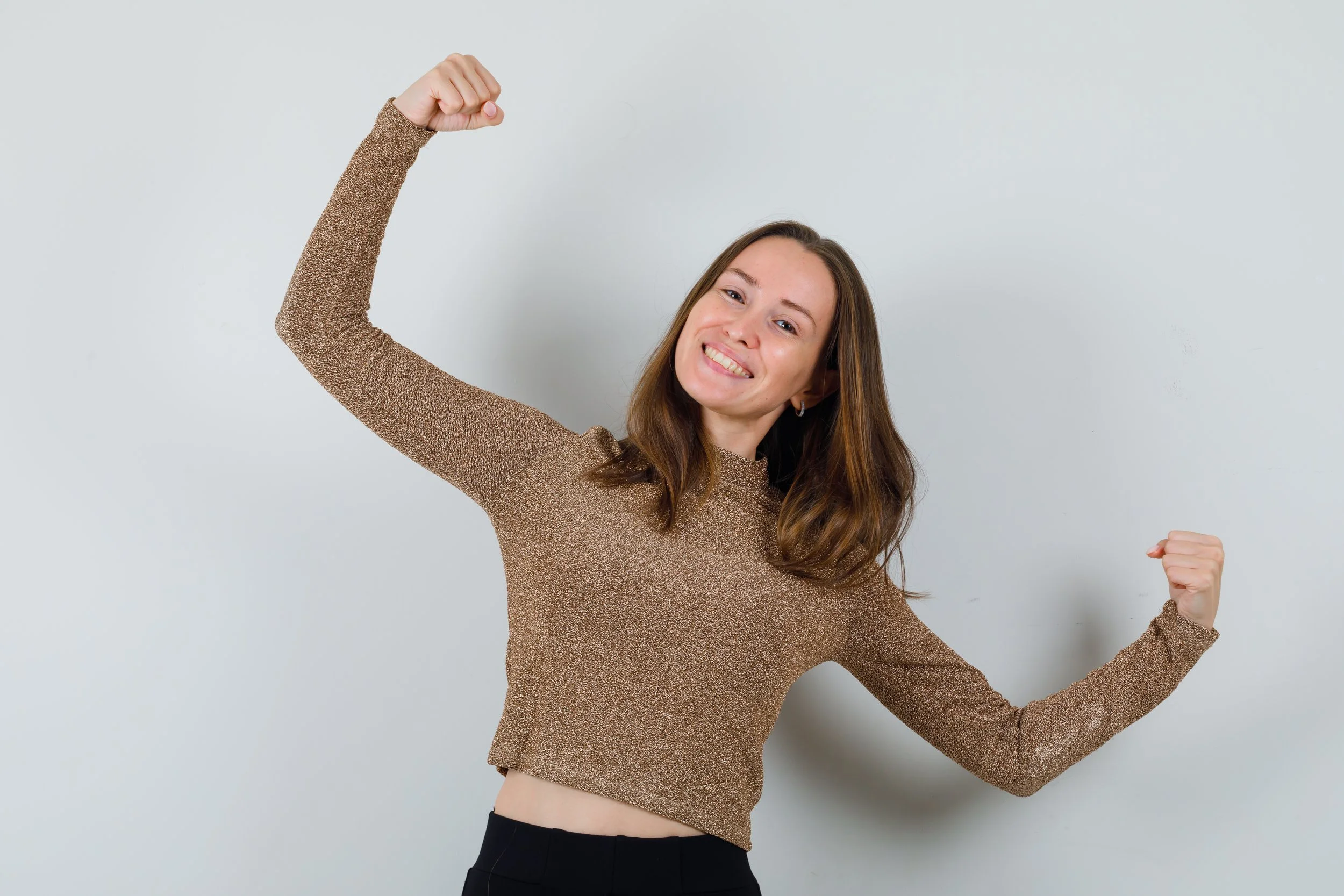 smiling woman flexing her arms
