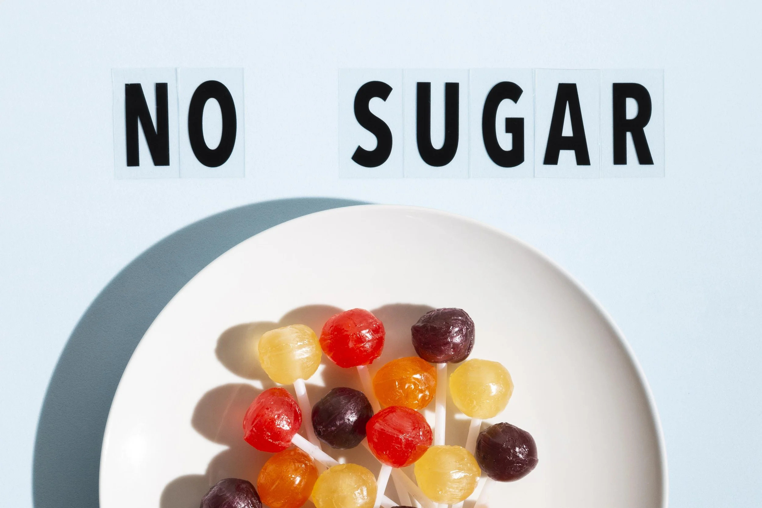 colorful lolllipops on a plate sugar free text