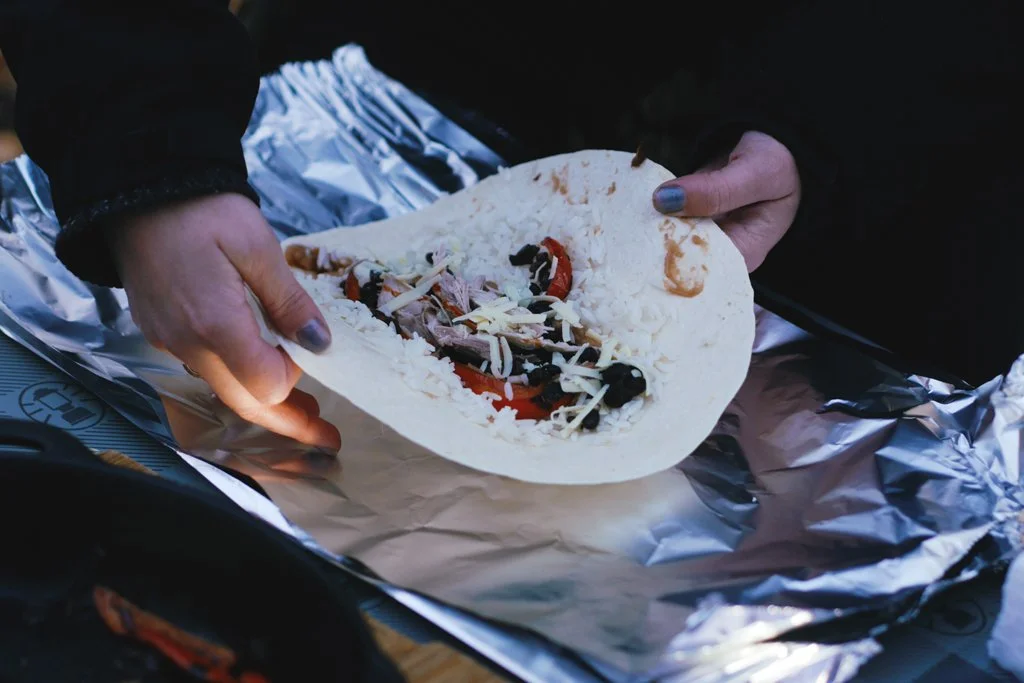   Preparing rabbit burritos, ready for cooking in the dutch oven.  