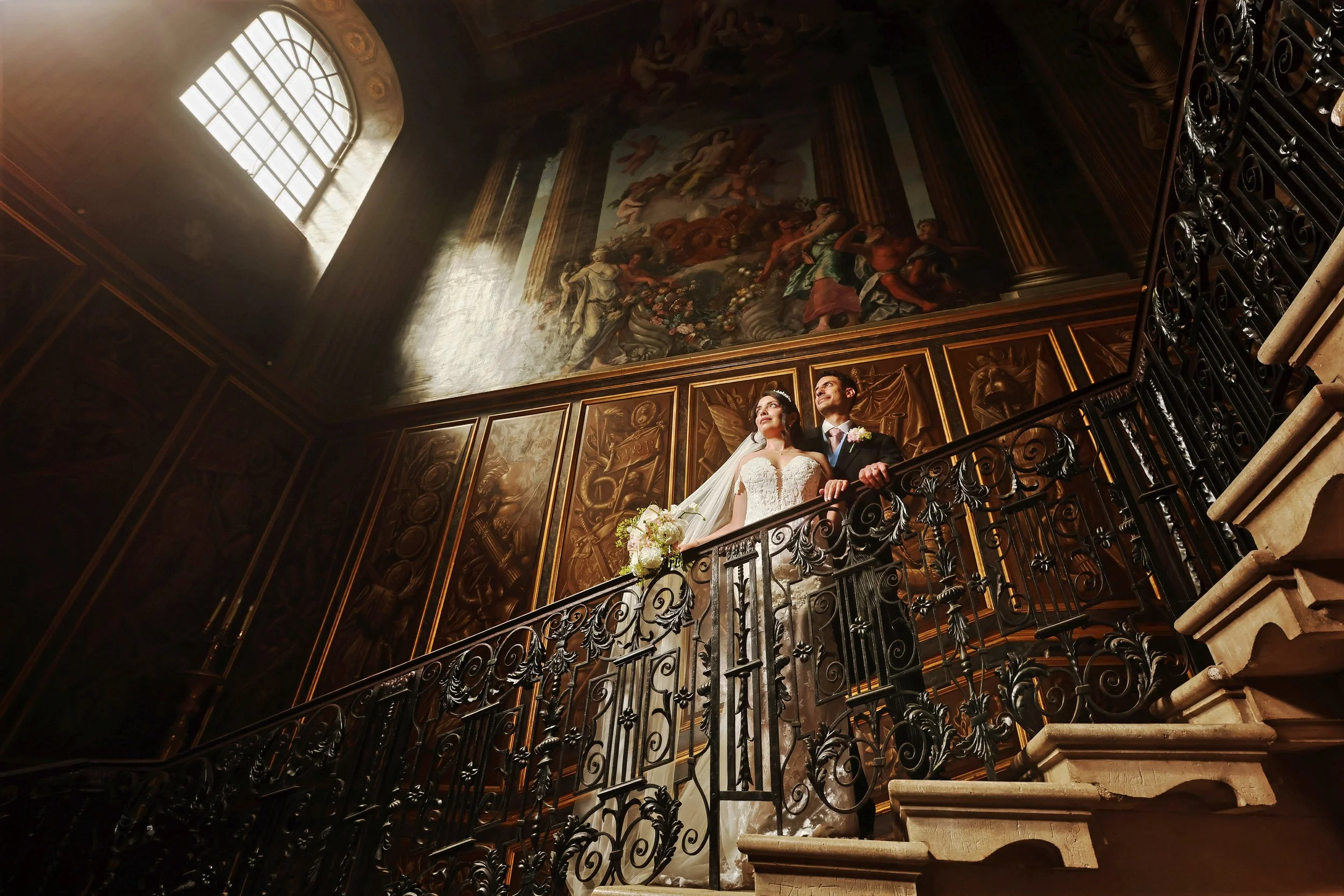 Bride and groom on the King's Staircase at Hampton Court Palace