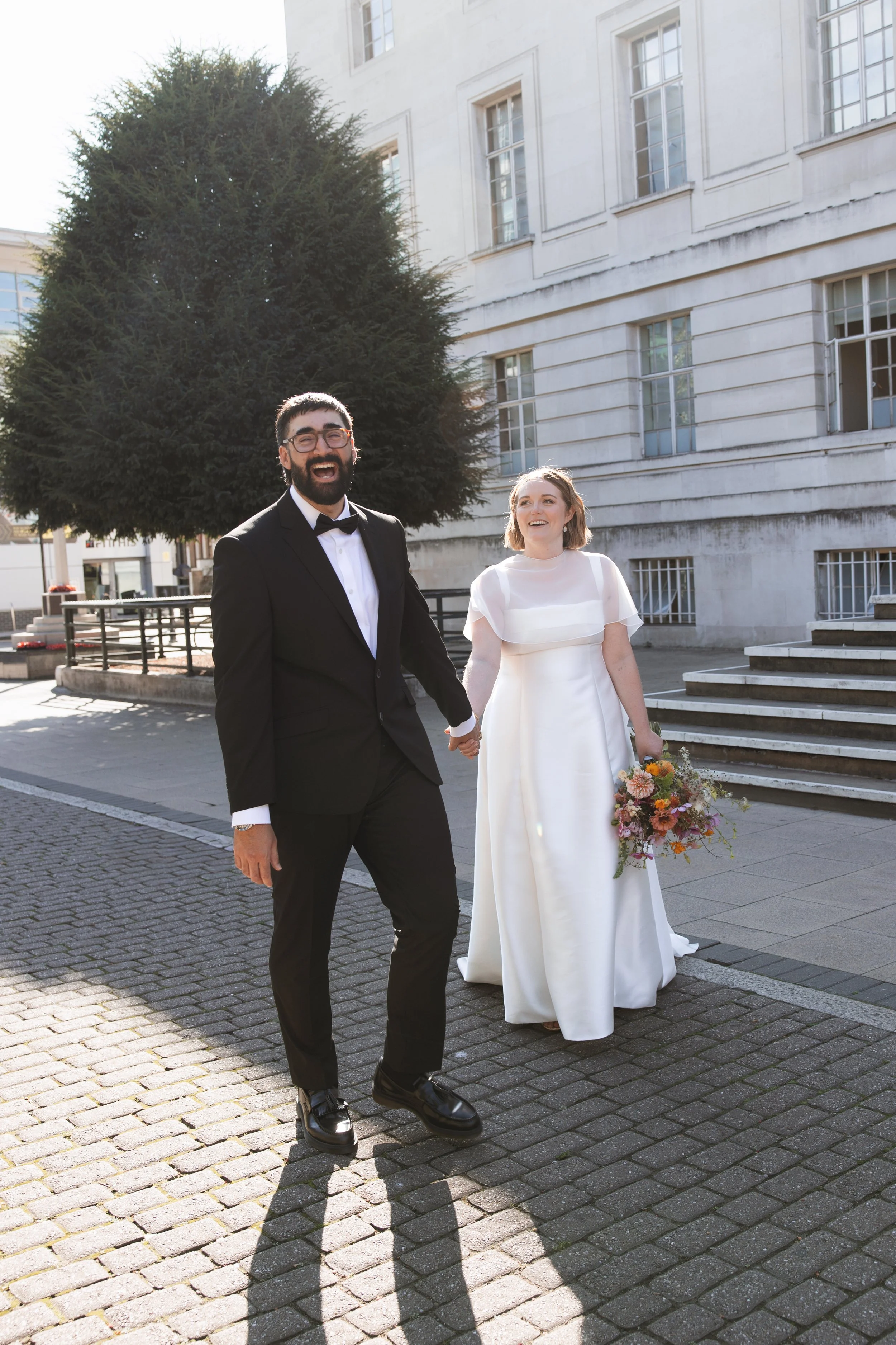 Couple leaving Hackney Town Hall after their London wedding
