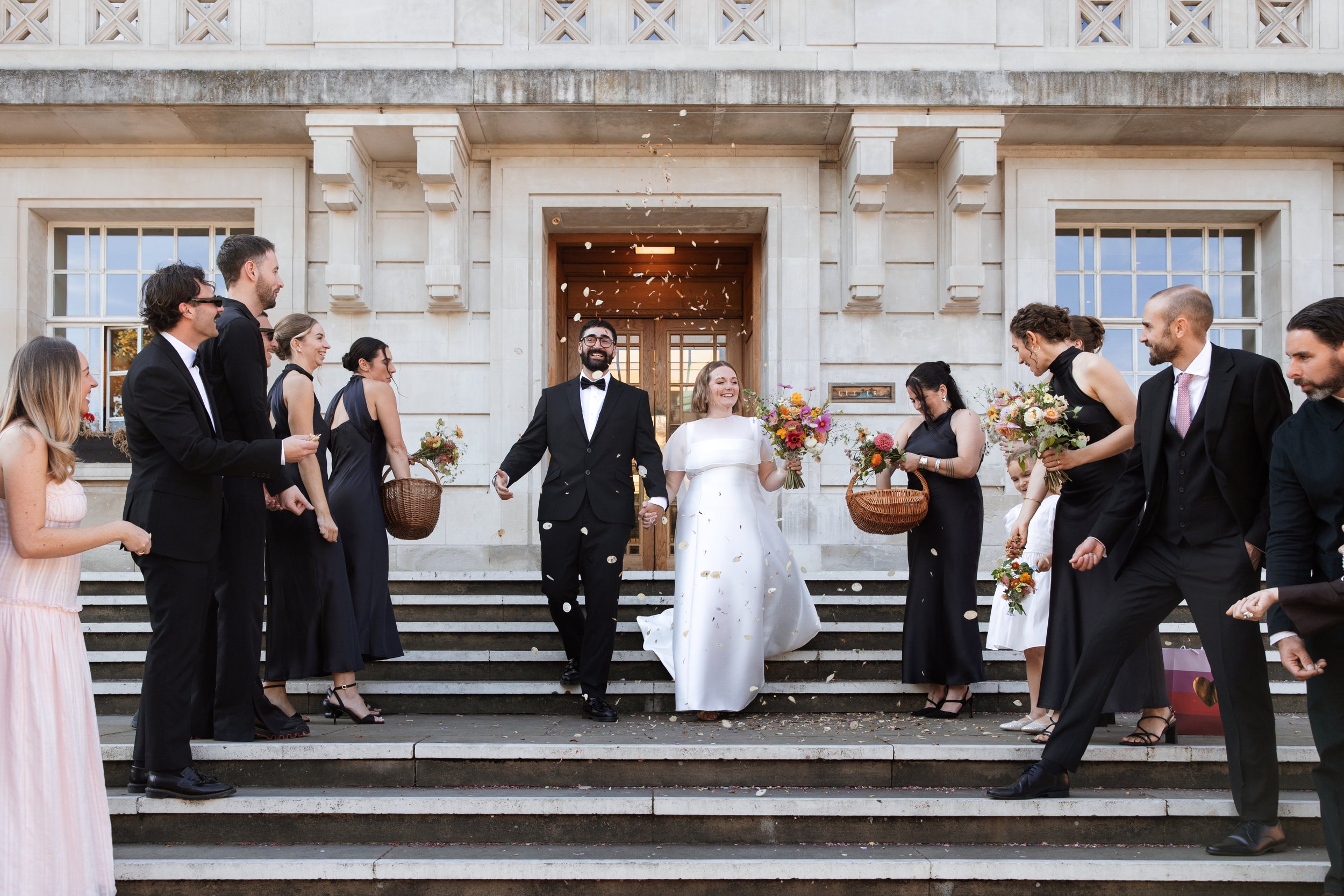 Couple leaving Hackney Town Hall after their London wedding
