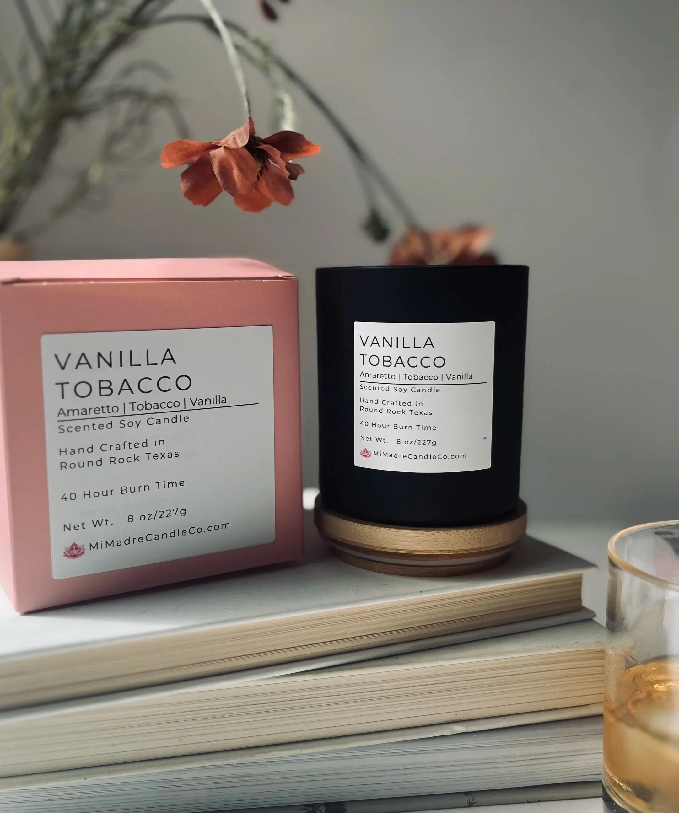 vanilla scented candle in black jar, minimalisitc and packaged with a pink box.