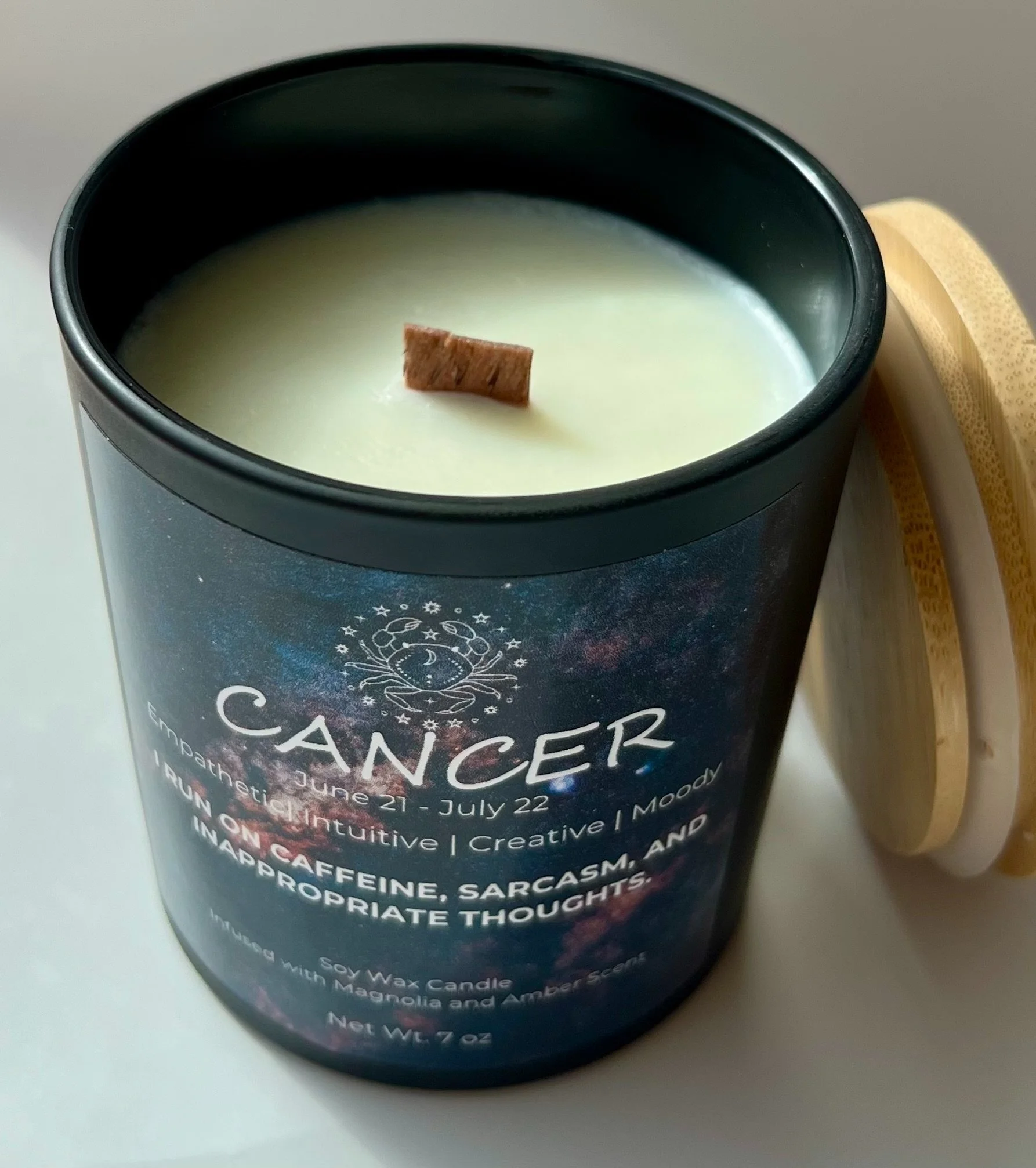 a handcrafted soy wax candle collection inspired by zodiac signs with deep celestial themed designs
