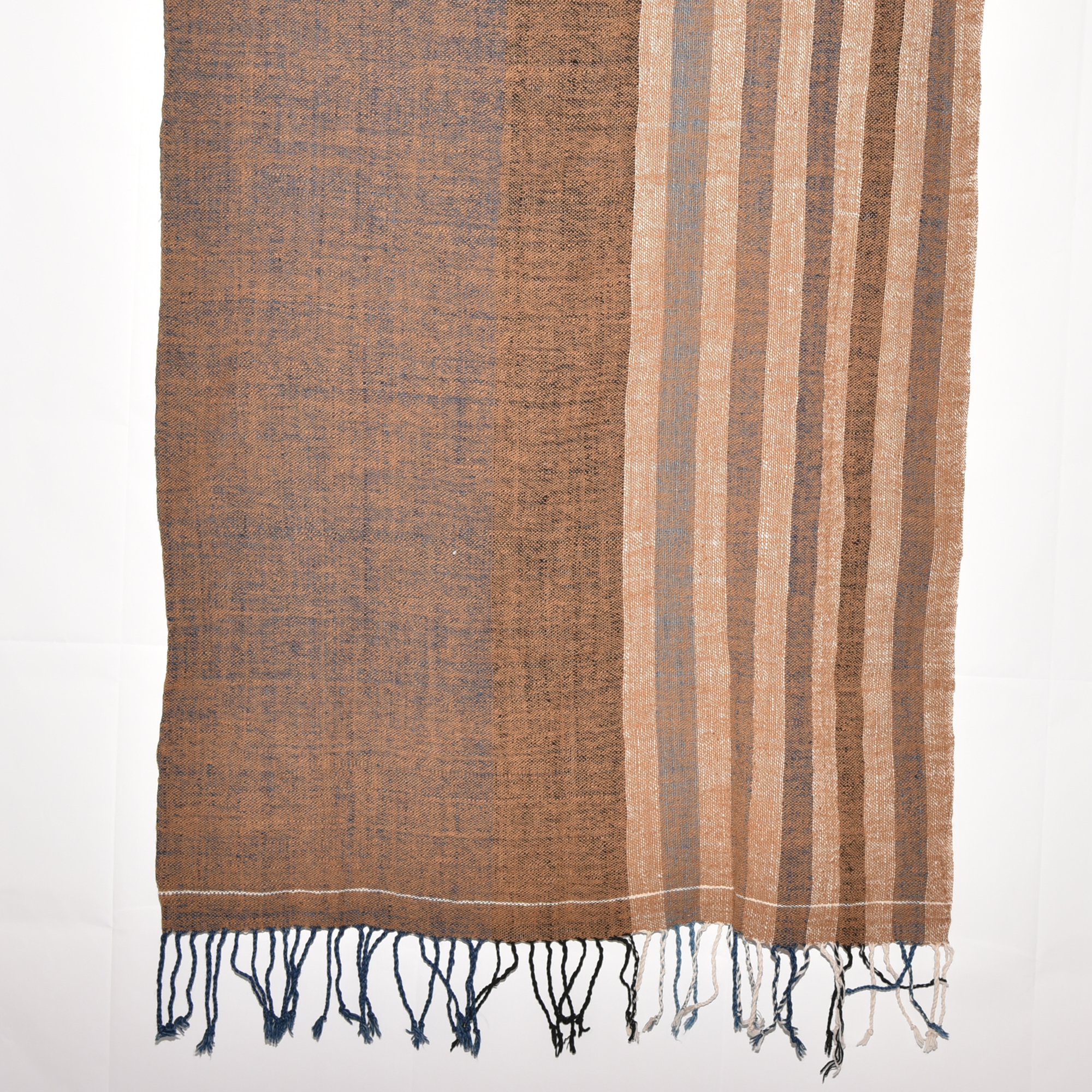 Hand-spun, hand-dyed, and hand-woven shawl made from thick organic cotton, featuring stripes in brown, tan, indigo, black, and white, with tassels at both ends. The shawl measures 2m x 70cm.