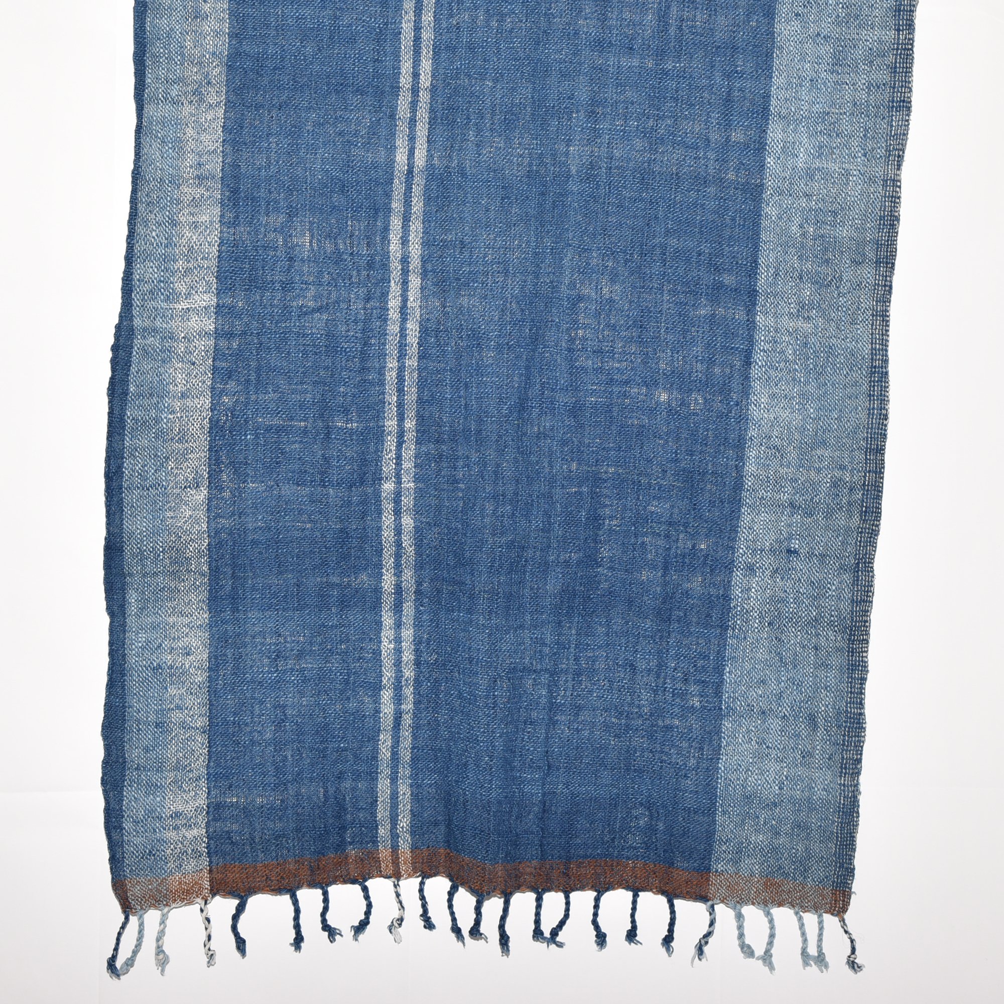 Hand-spun, hand-dyed, and hand-woven indigo and white striped organic cotton shawl with tassels, measuring 2m x 80cm.