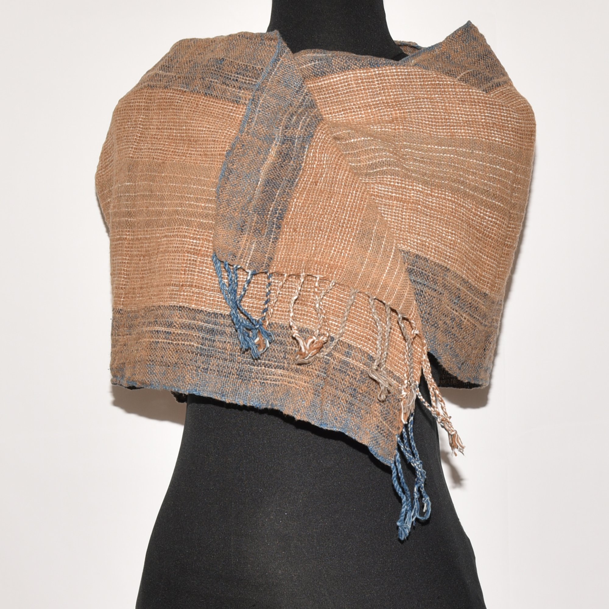 Hand spun, hand dyed and hand woven thick organic cotton striped scarf with brown, tan, indigo, and white, with tassels at each end. Measures 2m x 38cm.