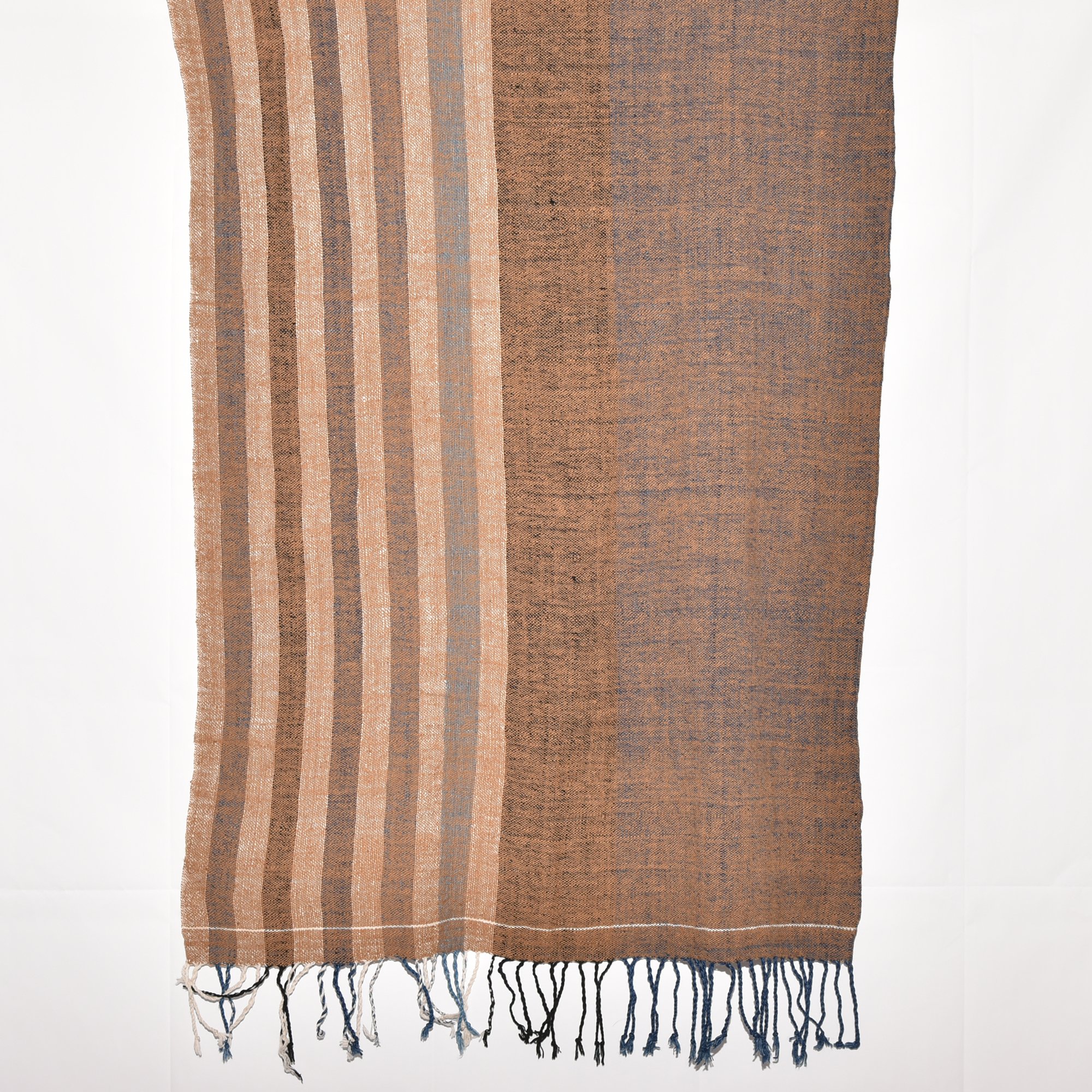 Hand-spun, hand-dyed, and hand-woven shawl made from thick organic cotton, featuring stripes in brown, tan, indigo, black, and white, with tassels at both ends. The shawl measures 2m x 70cm.