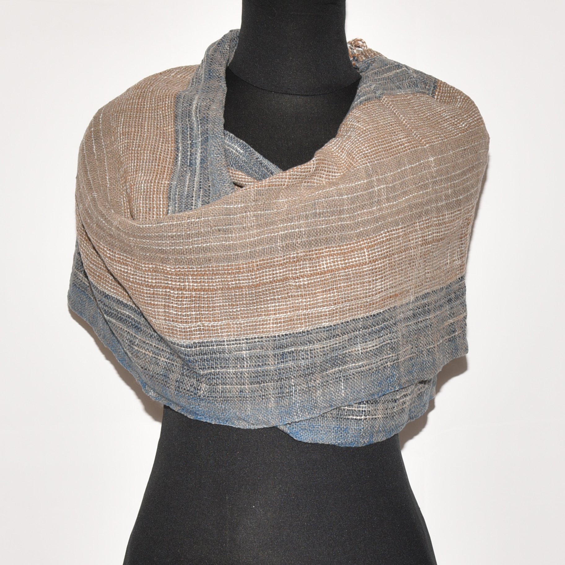 Hand-spun, hand-dyed, and hand-woven organic cotton scarf with brown, tan, indigo, and white stripes and tassels.