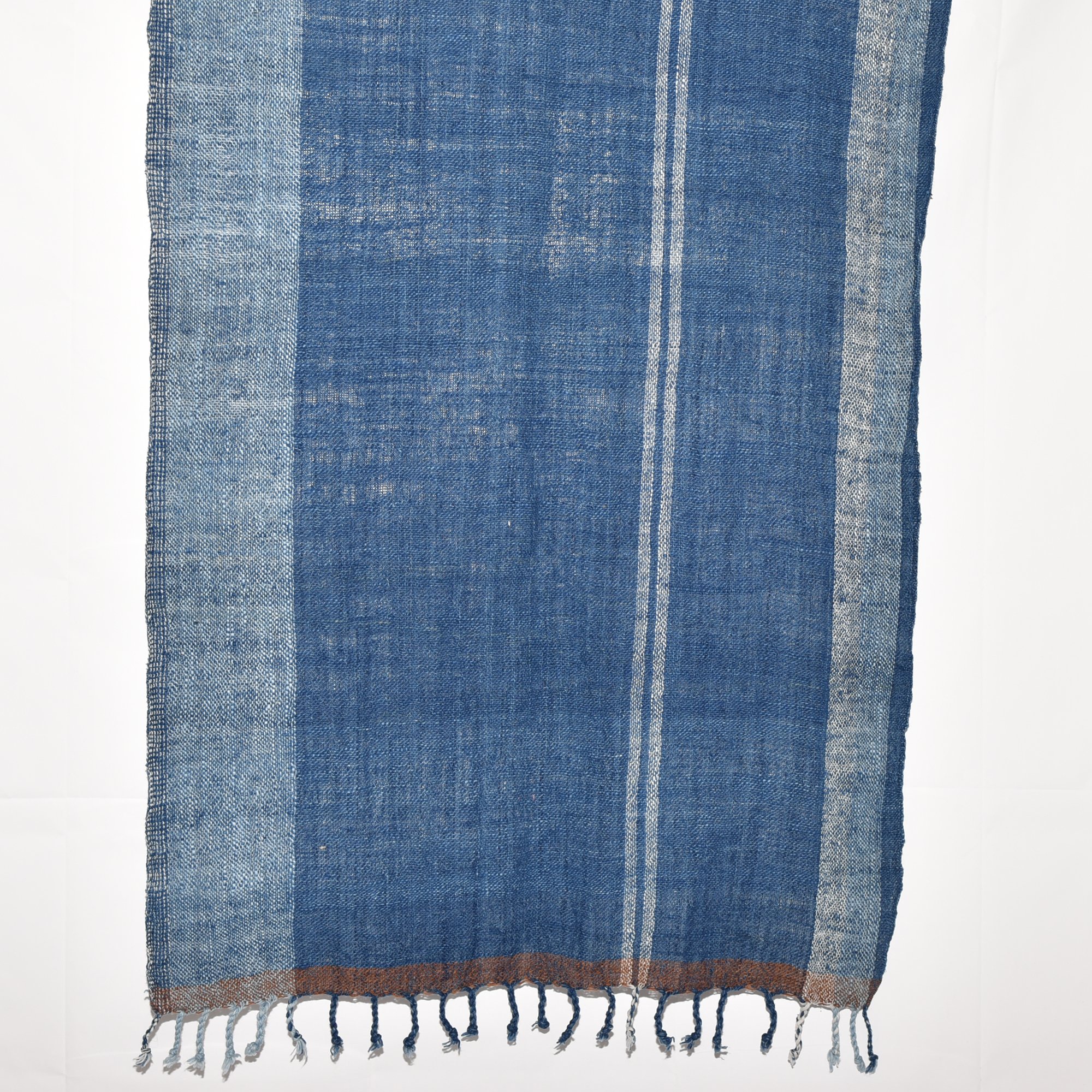 Hand-spun, hand-dyed, and hand-woven indigo and white striped organic cotton shawl with tassels, measuring 2m x 80cm.