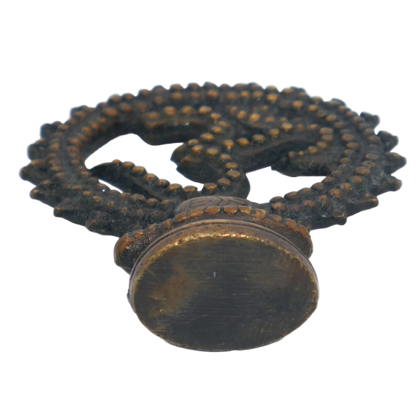 Bottom of a brass om statue.png