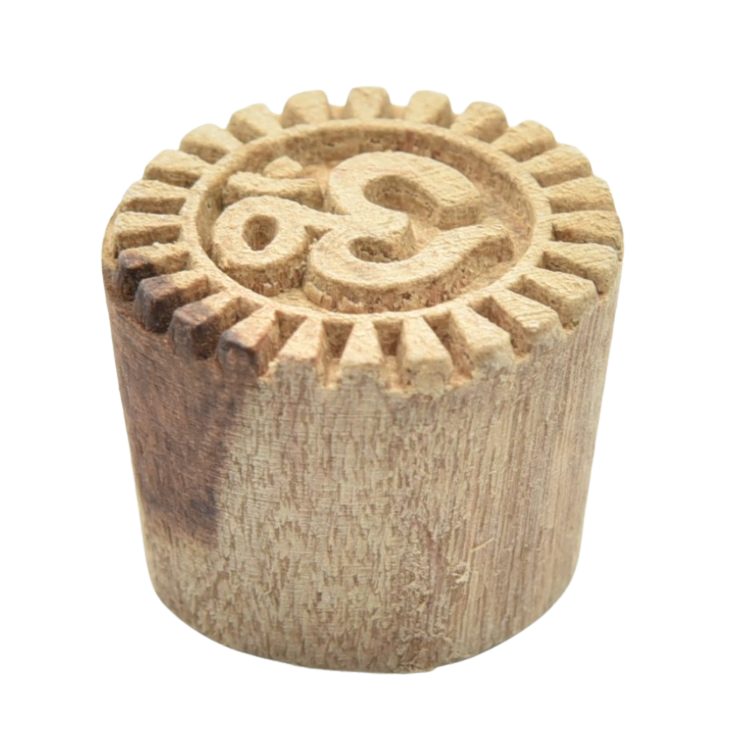 Small hand-carved Indian wooden printing block with the sacred 'Om' symbol.