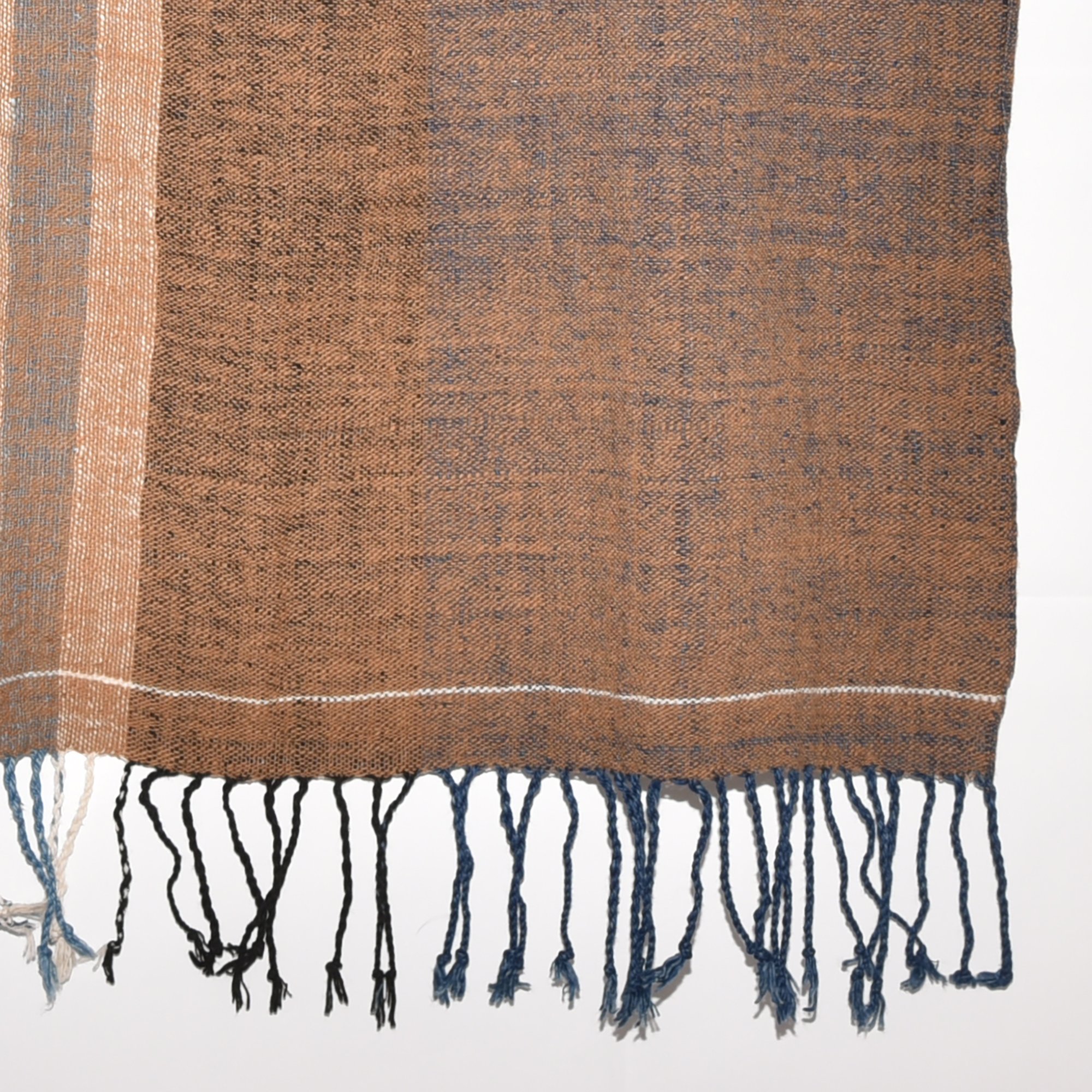 Hand-spun, hand-dyed, and hand-woven shawl made from thick organic cotton, featuring stripes in brown, tan, indigo, black, and white, with tassels at both ends. The shawl measures 2m x 70cm.