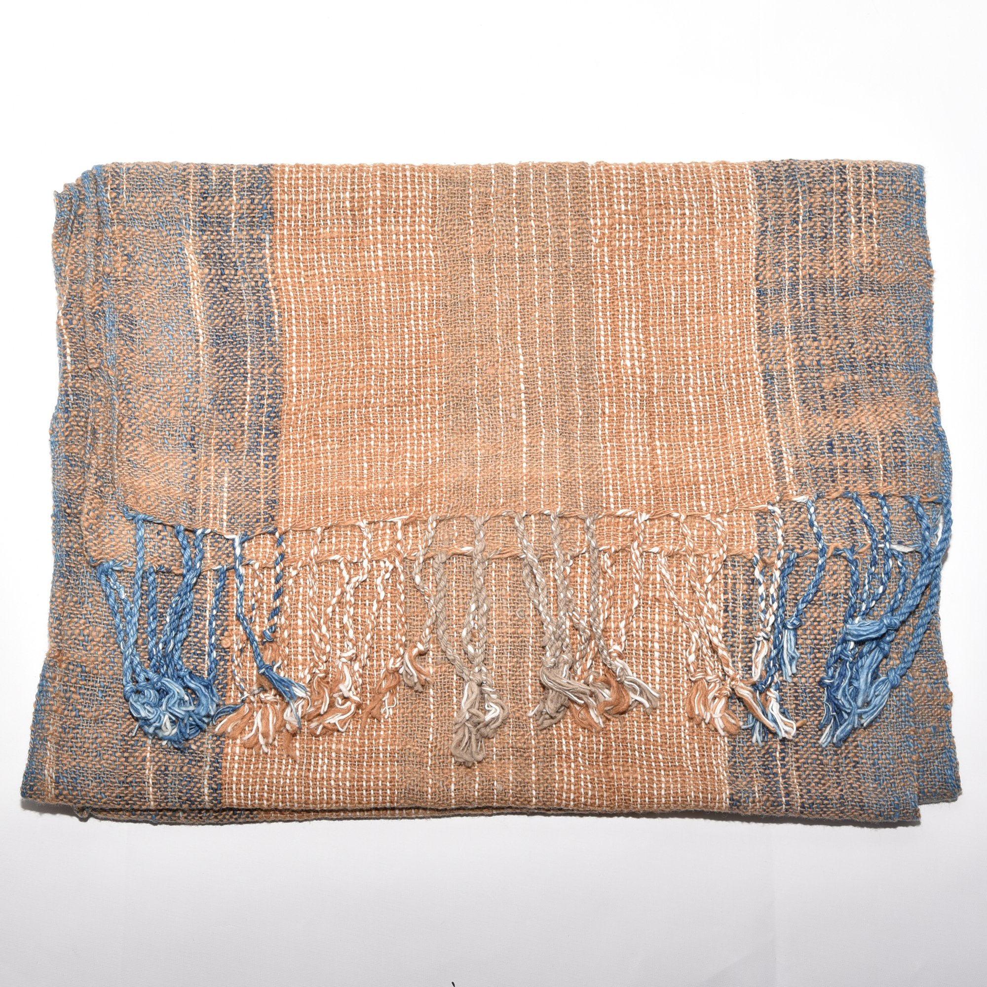 Hand spun, hand dyed and hand woven thick organic cotton striped scarf with brown, tan, indigo, and white, with tassels at each end. Measures 2m x 38cm.