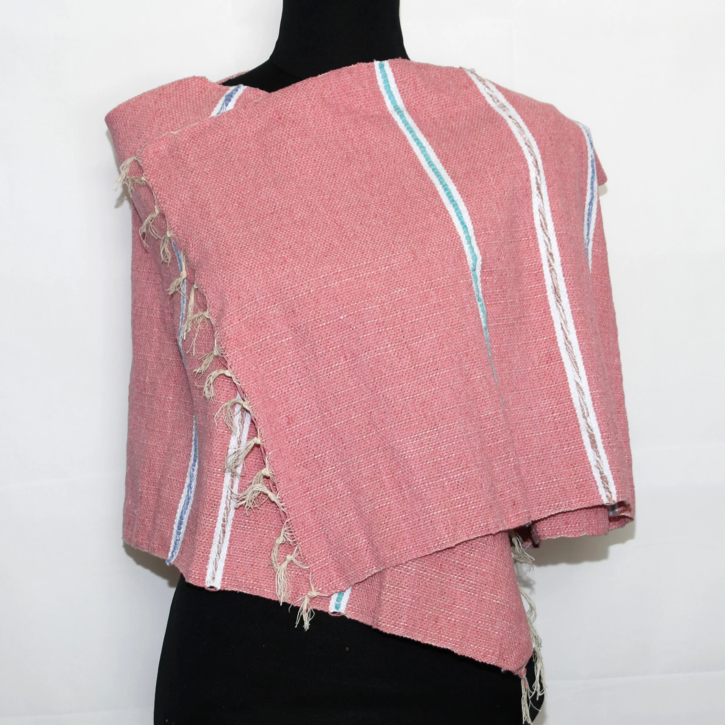 A salmon pink and white striped scarf made from thick cotton, with thicker white stripes and vibrant coloured cotton beading
