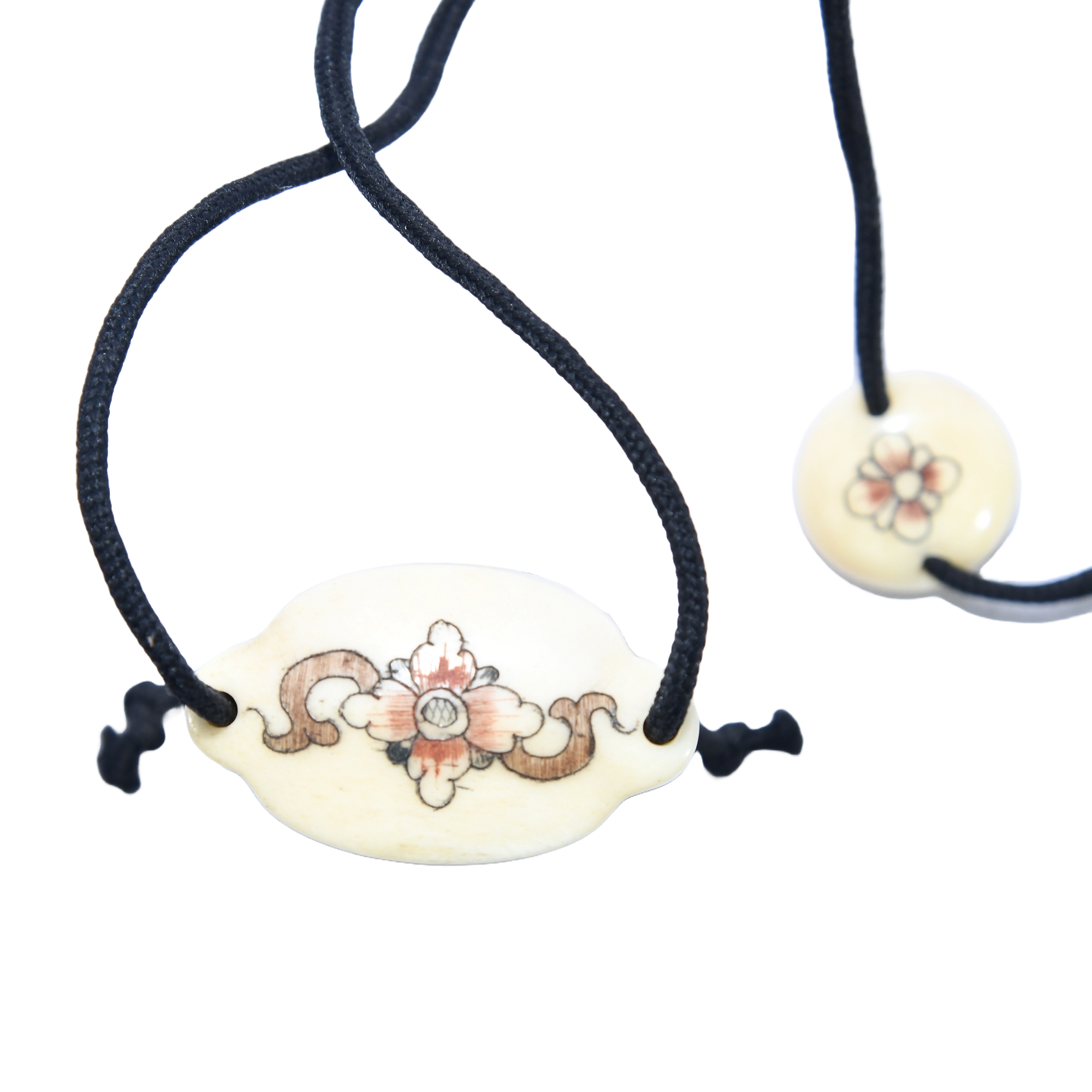 A meticulously crafted Japanese bone inro with two compartments, featuring Japanese calligraphy and an A ojime fastener.