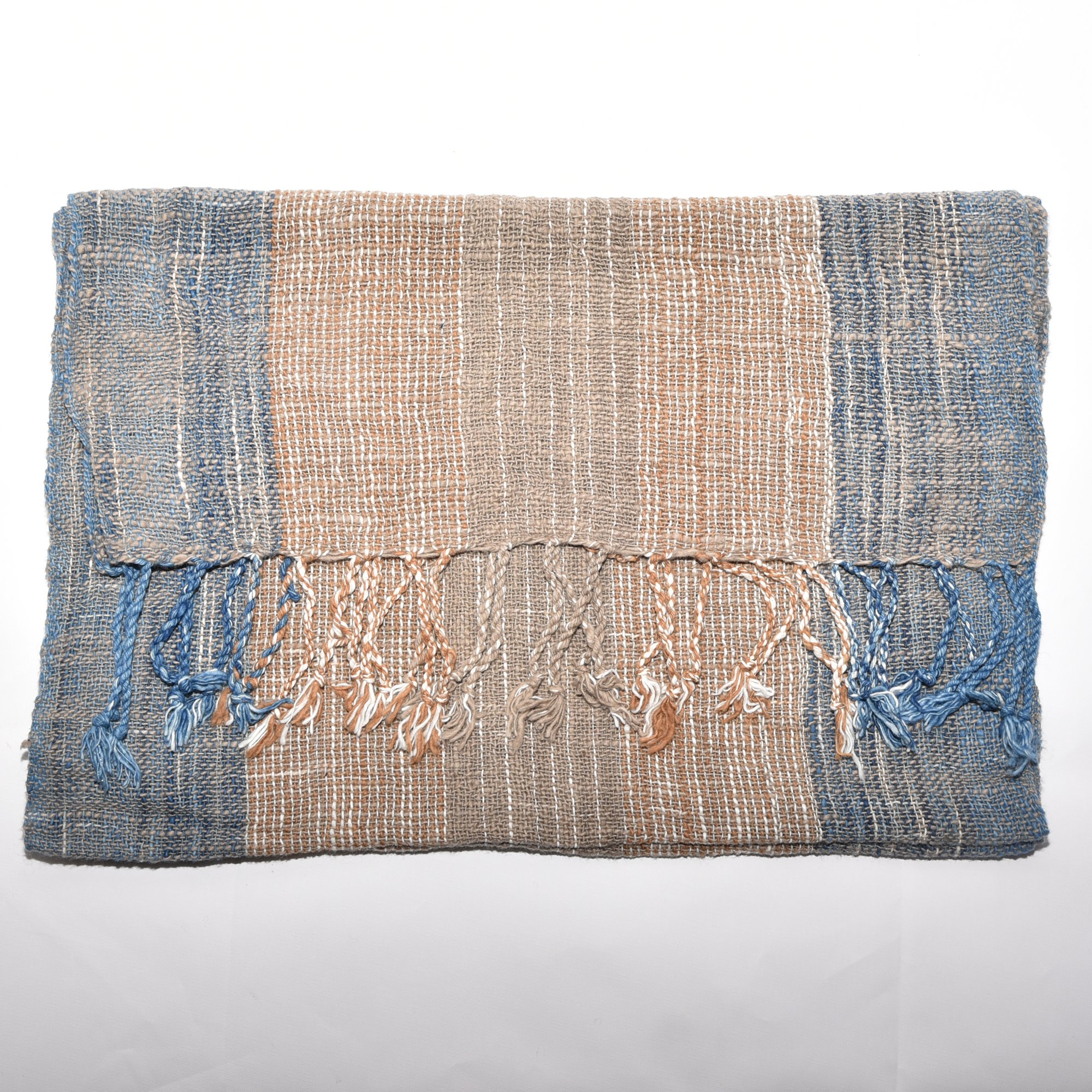Hand-spun, hand-dyed, and hand-woven organic cotton scarf with brown, tan, indigo, and white stripes and tassels.