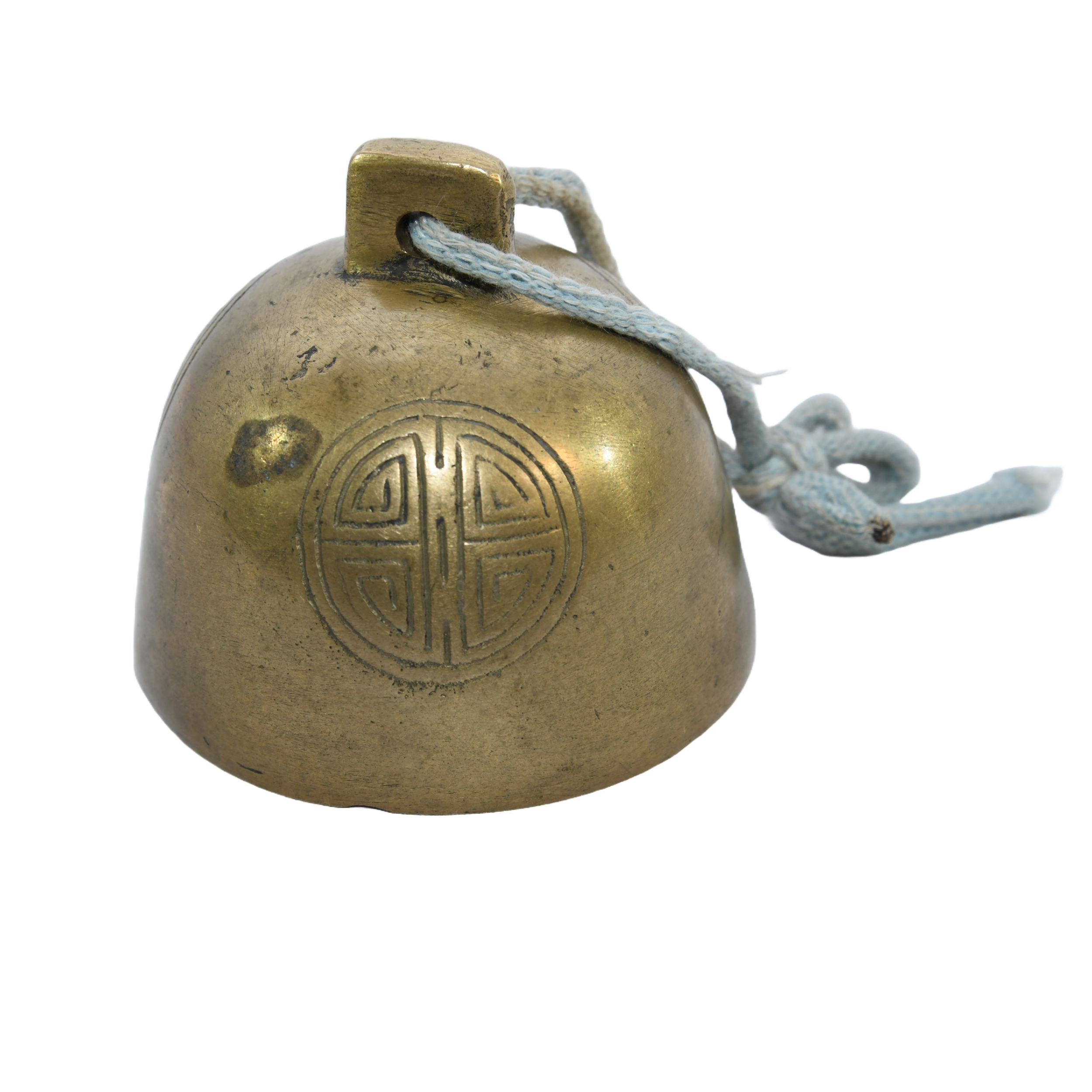 Antique Tibetan brass yak bell. It's a small, round bell with intricate carvings.