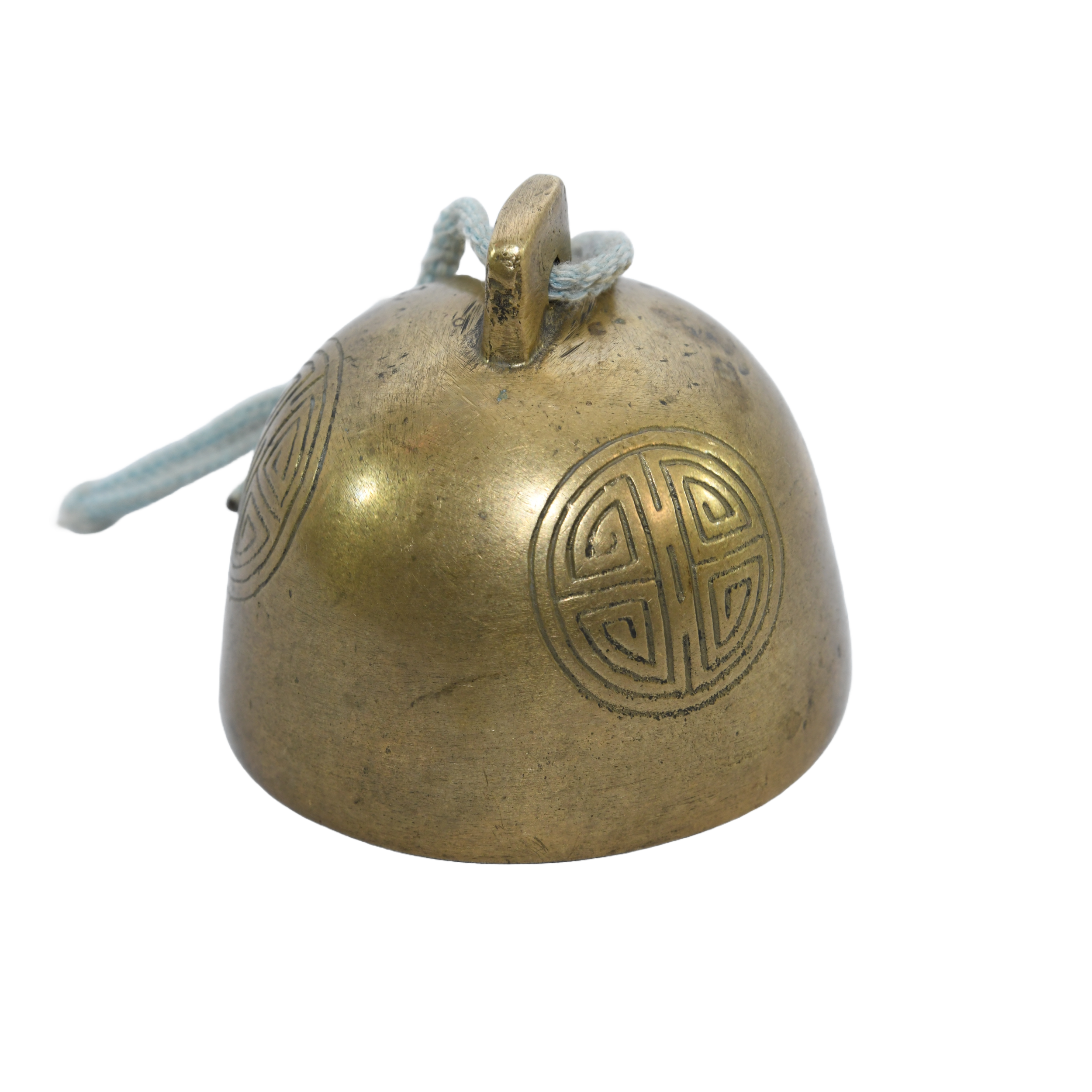 Antique Tibetan brass yak bell. It's a small, round bell with intricate carvings.