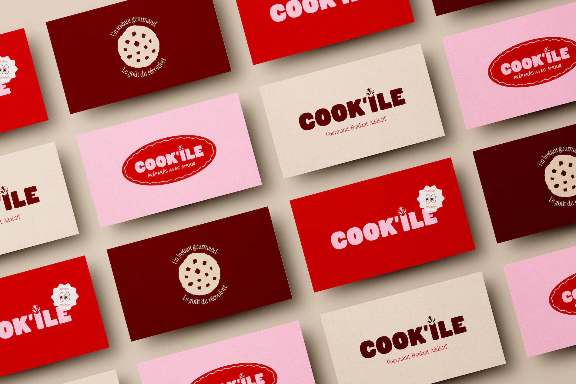 Multiple overlapping business cards for Cook'ile, a food brand, in red, pink, and cream colors, with various logos and slogans like "Gourmand. Fondant. Addictif" and "Préparés avec Amour."