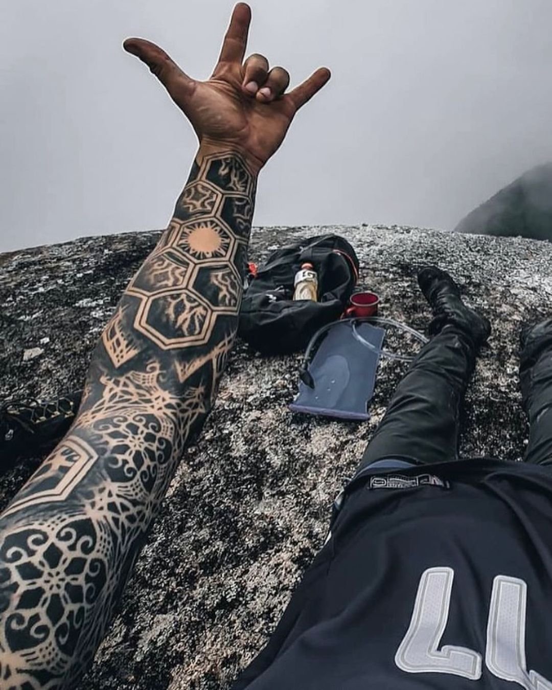 A detailed geometric sleeve tattoo featuring precise linework and symmetrical patterns, designed by Thiago Benevides in Lisbon, Portugal.