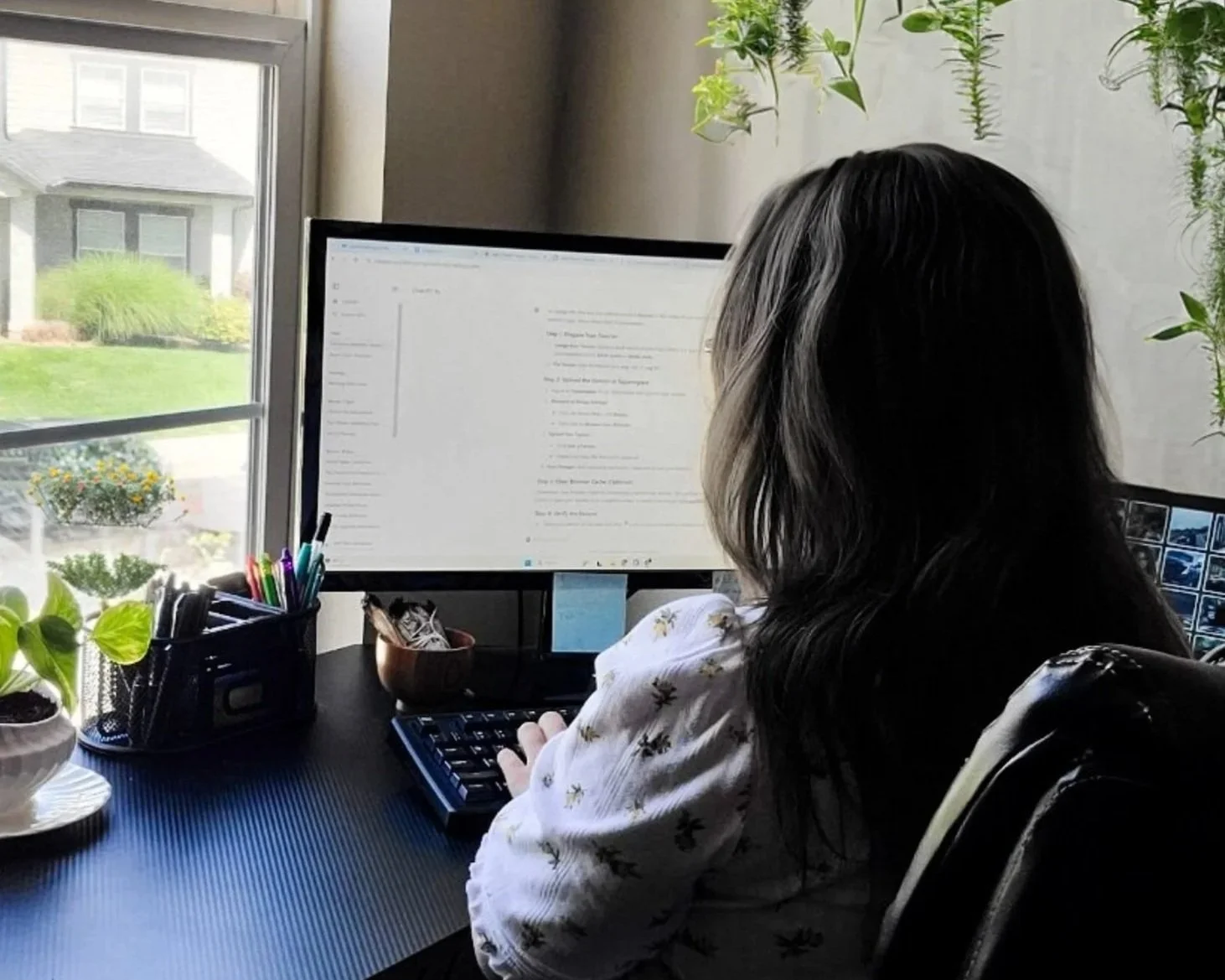 Web developer working at a desk, building custom websites and apps for small business clients.