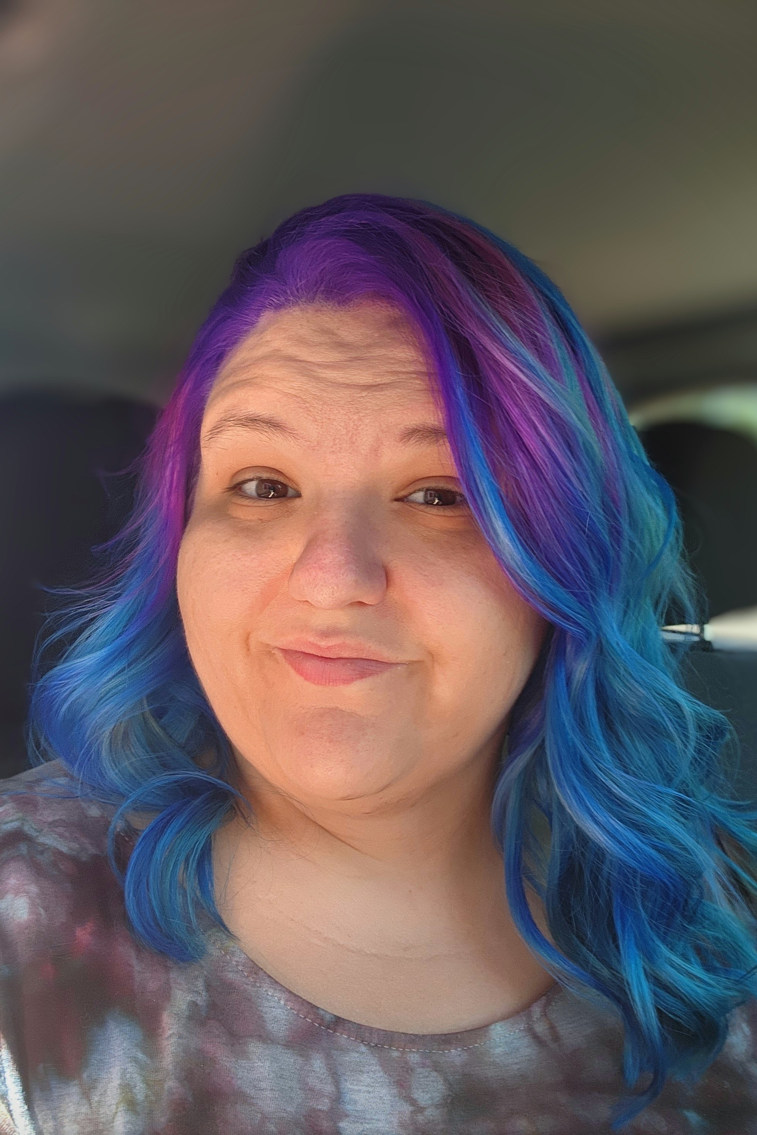 Jillian Paul - Office Manager; A Young woman with purple hair in an ombre to blue
