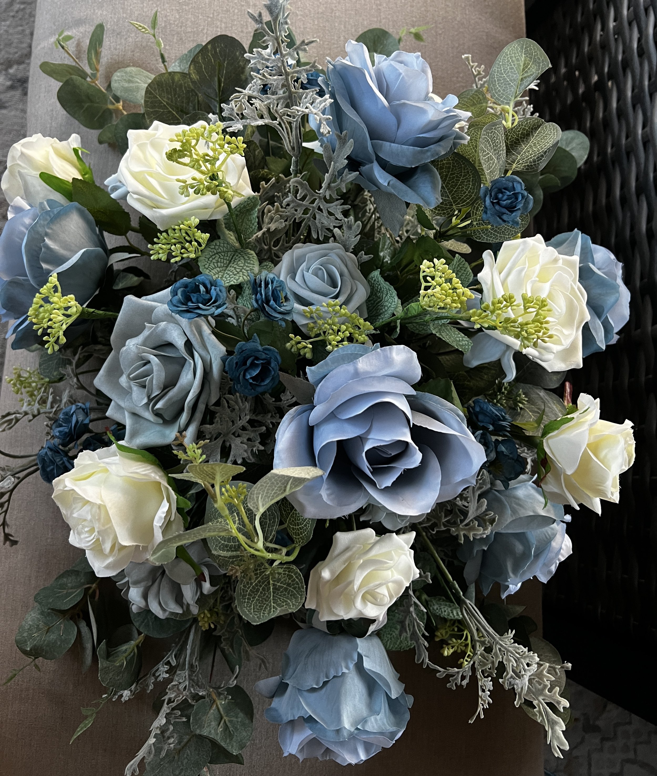 This beautiful white and dusty blue floral arrangement for an arch or wedding table is $200 for a rental. We can also create a custom look for you.