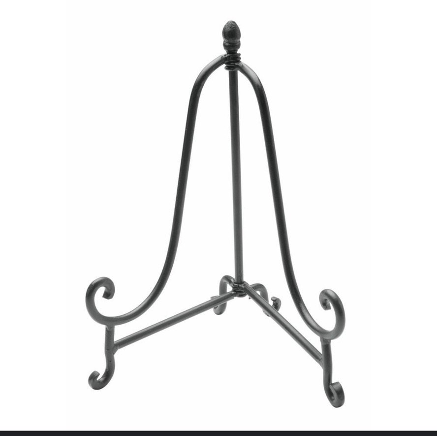 Black metal decorative easel stand with scroll design