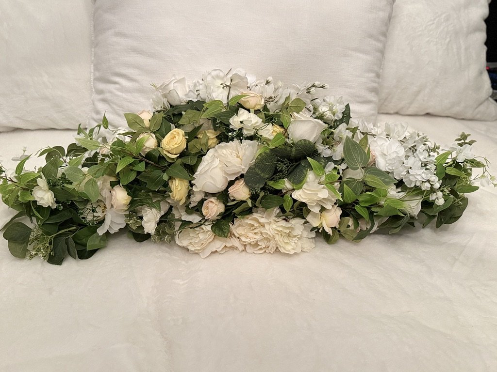 This beautiful yellow and white floral for an arch or wedding table is $200 for a rental.
