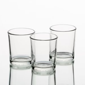Three empty clear glass tumblers on a white surface