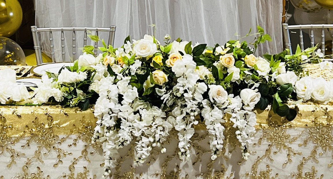 This beautiful yellow and white floral for an arch or wedding table is $250.00 for a rental.