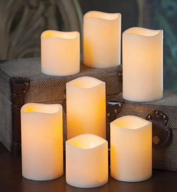 Collection of flameless LED candles on burlap covered boxes
