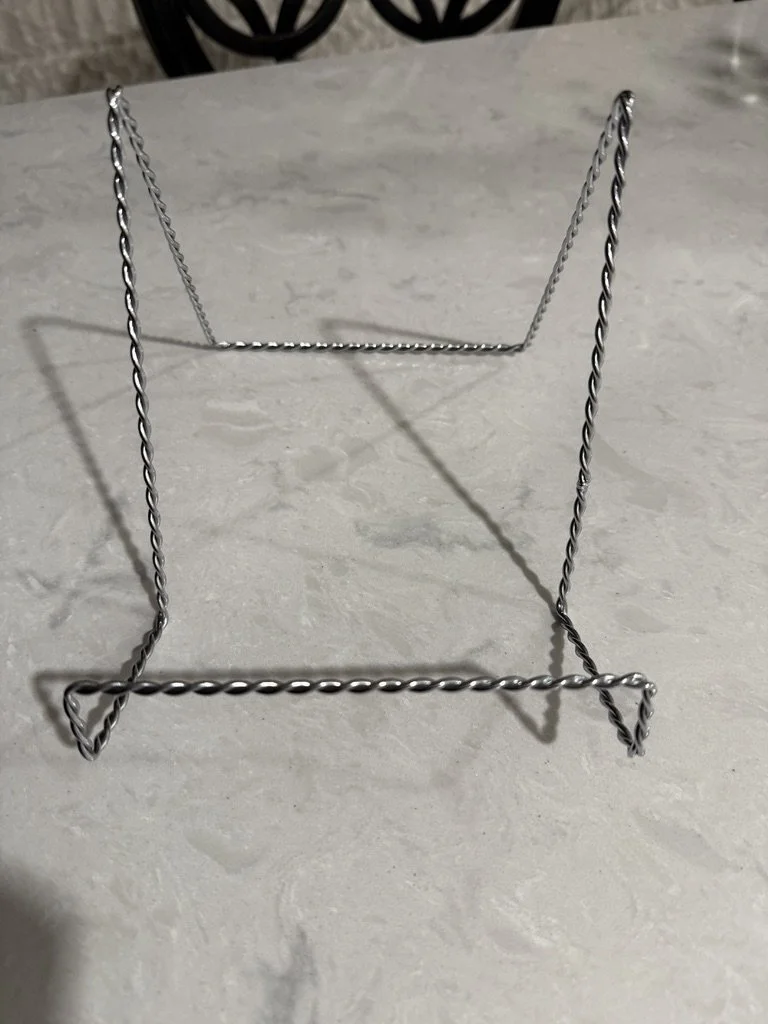 Twisted wire stand on light surface