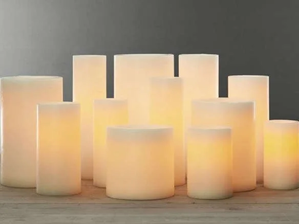 Group of lit pillar candles of varying heights