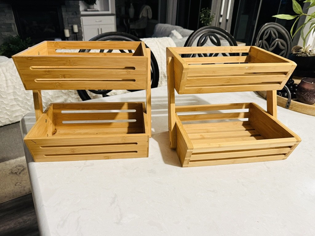 Two wooden tiered baskets on a countertop