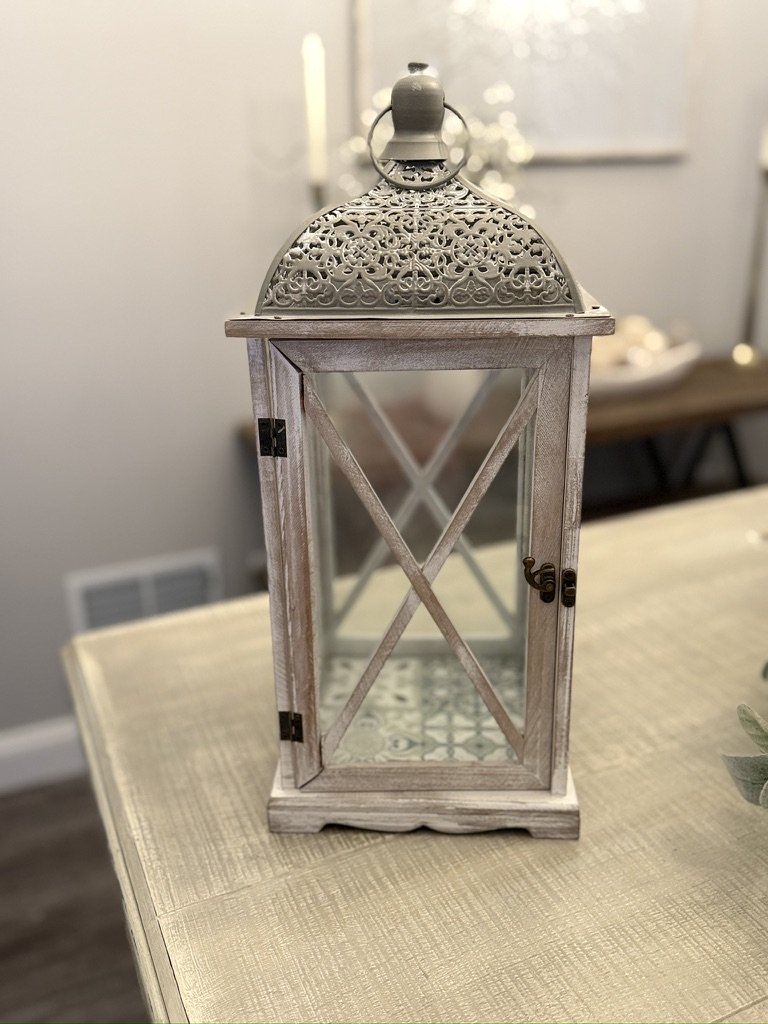 Decorative metal and glass lantern on a table