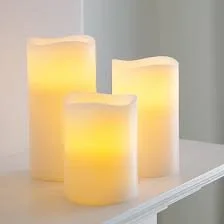 Three flameless LED candles on a shelf