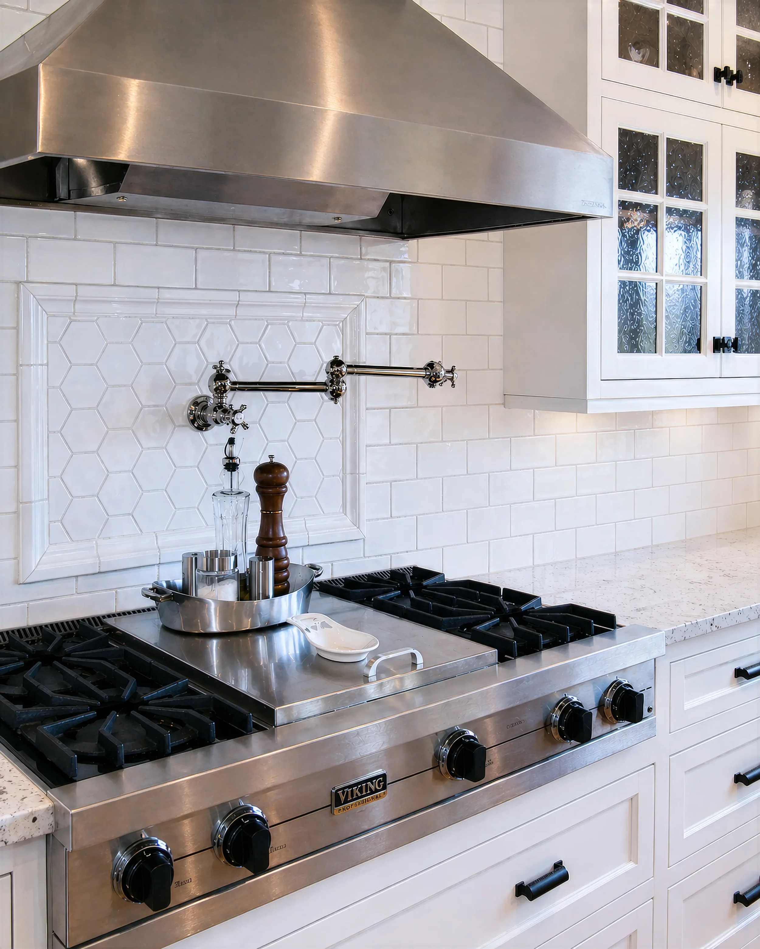 Contemporary farmhouse kitchen remodel in the Mapleton Hill district of Boulder, CO featuring close up view of stove with stainless steel range hood and wall mounted pot filler inside white inset tile backsplash