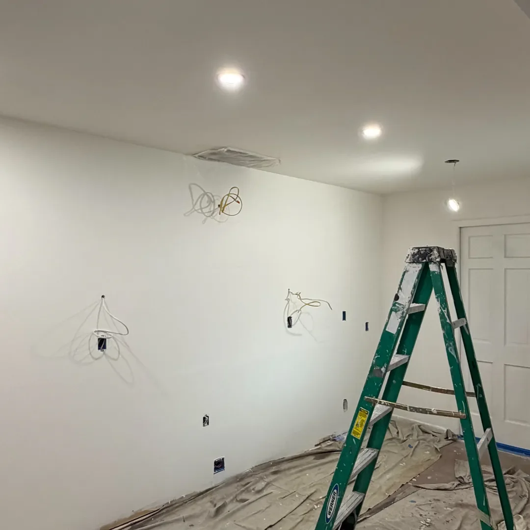 Freshly painted smooth textured drywall with exposed electrical wires in a Longmont, CO kitchen in the process of being renovated.