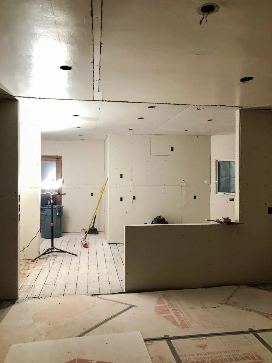 Kitchen remodel in progress in Louisville, CO featuring unfinished drywall panel wall and ceiling installation.