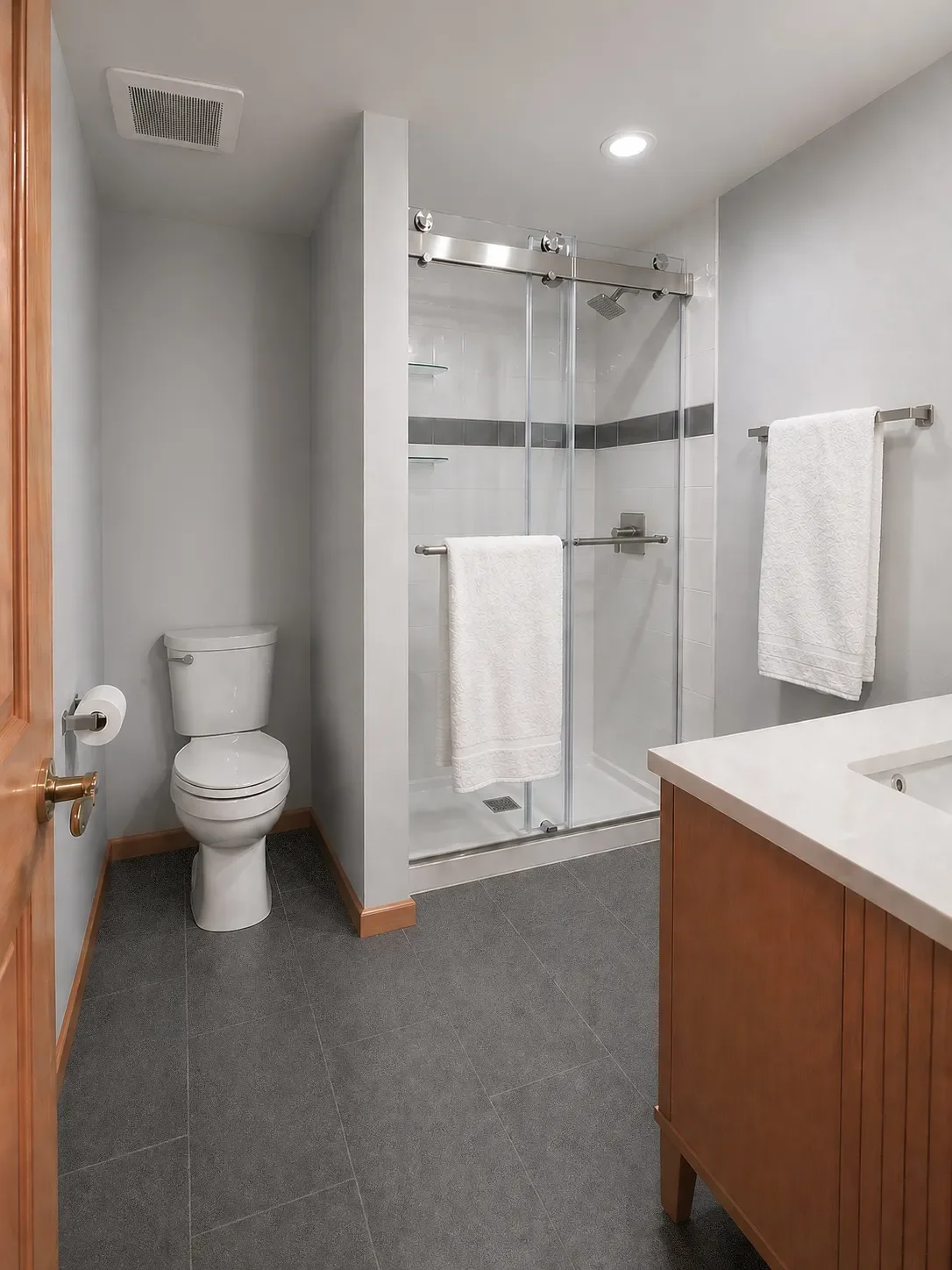 View of walk-in sliding glass door shower and partially enclosed toilet in Niwot, CO contemporary bathroom remodel