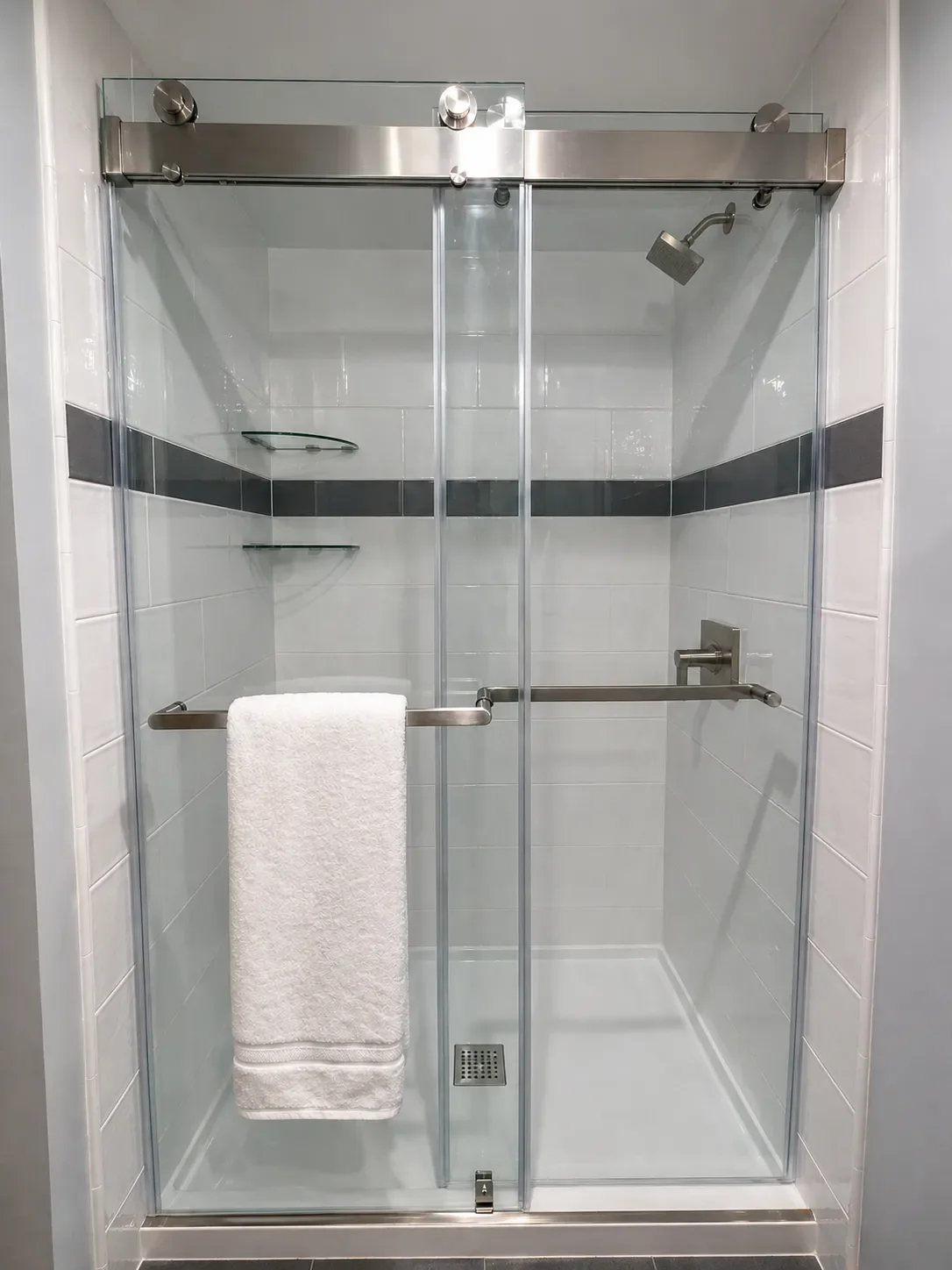 Shower view of Niwot, CO bathroom remodel featuring frameless sliding glass shower doors