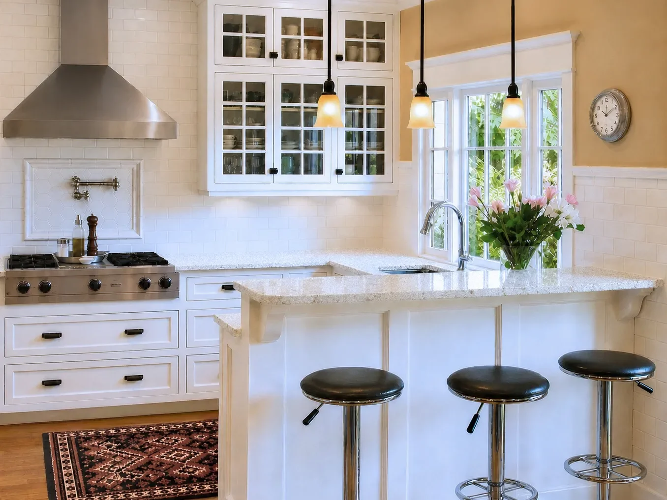 Modern kitchen with dark wood cabinets, stainless steel appliances, decorative tile backsplash, large island, and pendant lighting.