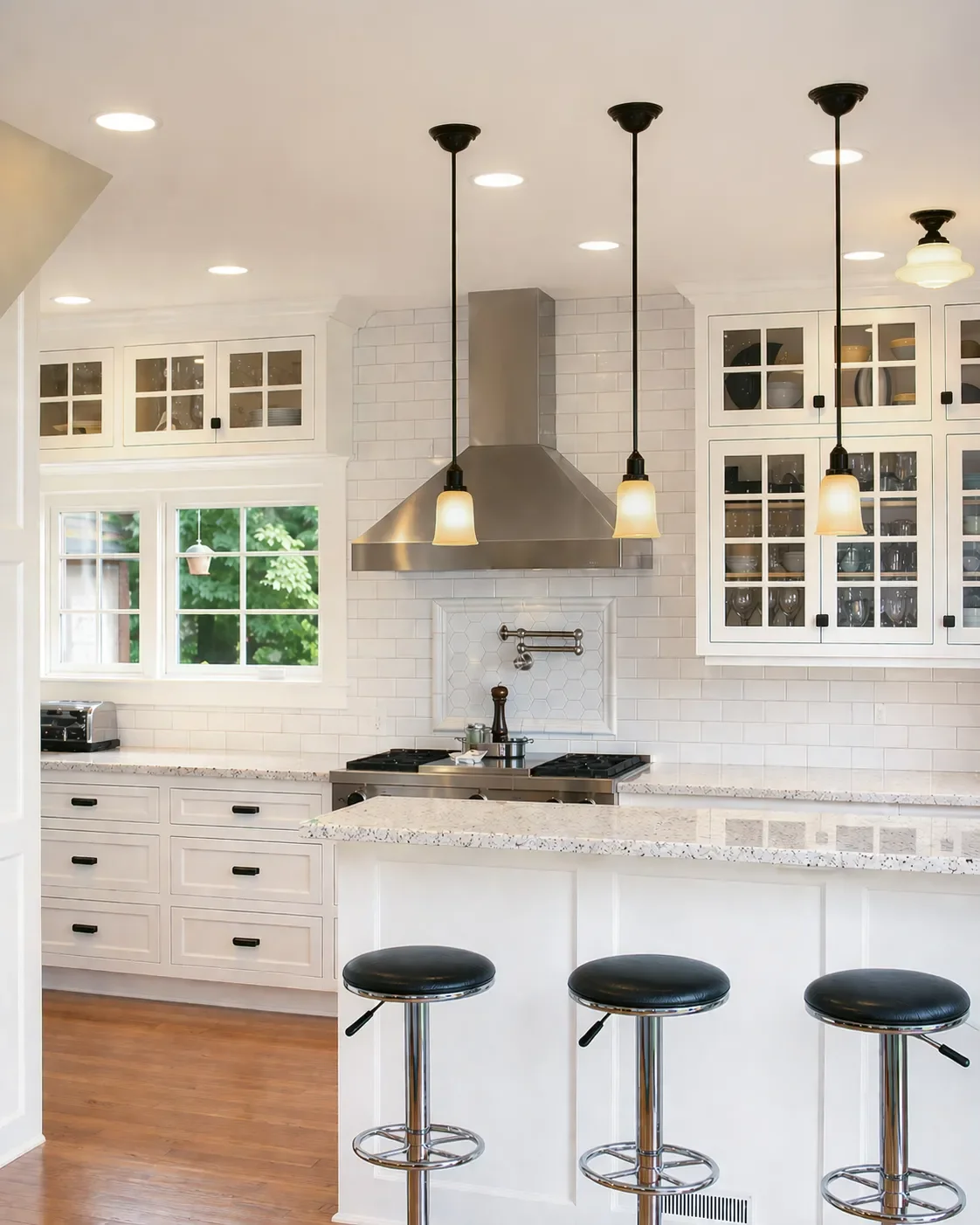 Modern kitchen with dark wood cabinets, stainless steel appliances, and decorative tile backsplash.