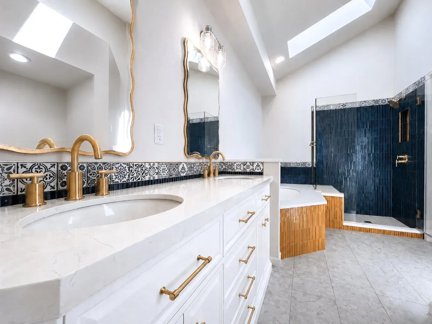 Remodeled master bathroom in Gunbarrel, CO overlooking stone tiled heated floor, walk-in shower with shower bench, and oversized soaking tub