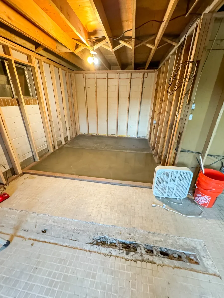 Unfinished basement remodel in progress showing uneven floor leveling in Boulder, CO