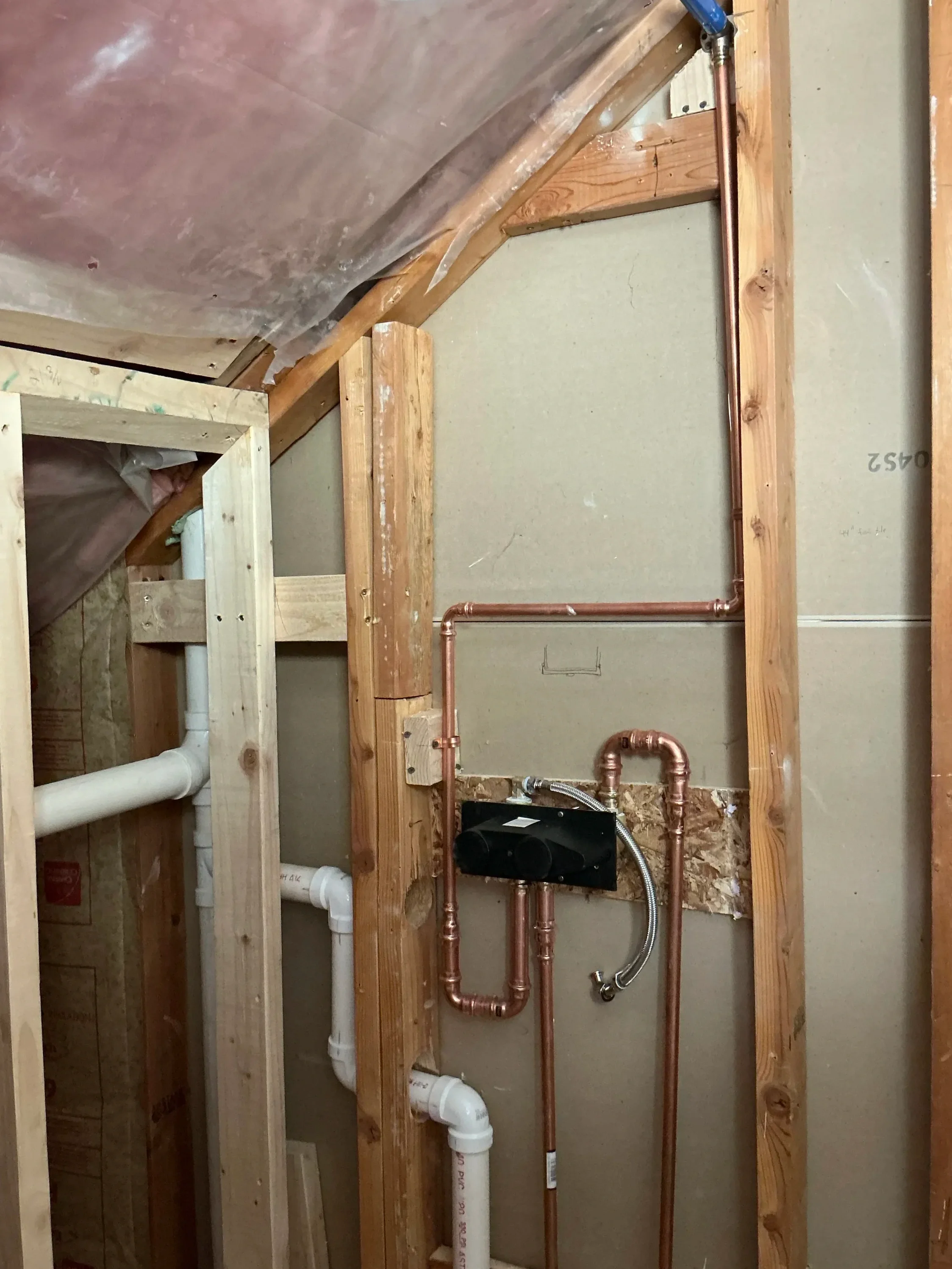 New copper plumbing and fresh drywall framing in a bathroom remodel in Boulder, CO work in progress