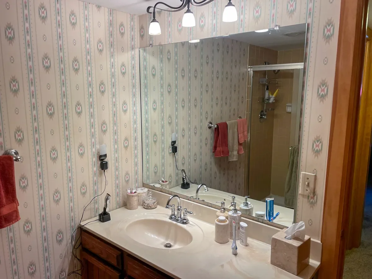Niwot, CO vintage southwestern bathroom remodel before photo overlooking vanity with vintage wallpaper