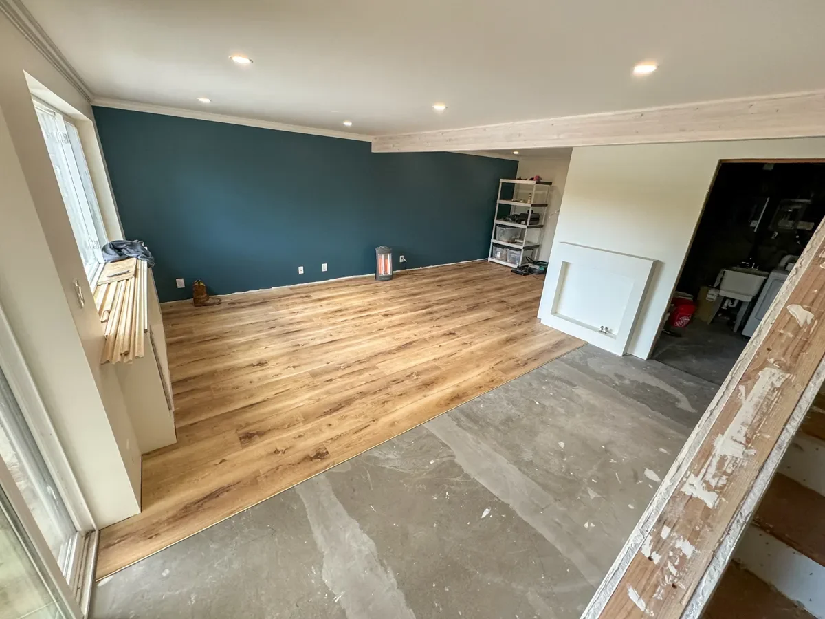 Partially remodeled walkout basement in Seven Hills, Boulder, CO featuring vinyl plank flooring install progress